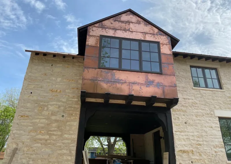 Copper metal panel facade on a stone building for Skylight Installation in River Grove