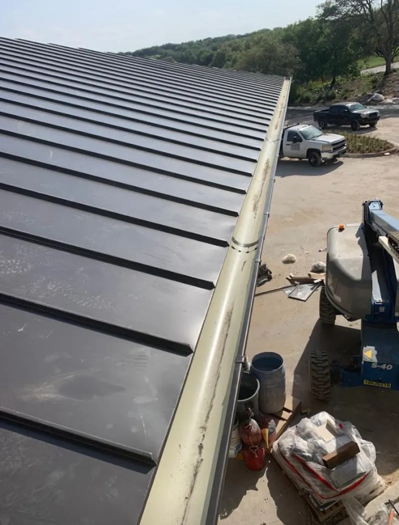 Standing seam panel and gutter detail on a metal roofing jobsite in River Grove